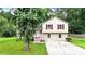 Inviting split-level home with red shutters surrounded by lush greenery at 132 Bishop Nw Rd, Cartersville, GA 30121