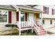 Welcoming front porch with red painted steps and freshly painted white railings at 132 Bishop Nw Rd, Cartersville, GA 30121