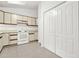 Well-lit kitchen with plenty of storage and white cabinets and appliances at 132 Bishop Nw Rd, Cartersville, GA 30121