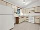 Kitchen with ample cabinet space, white appliances, and tiled floors at 132 Bishop Nw Rd, Cartersville, GA 30121