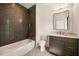 Elegant bathroom featuring modern grey tile, a sleek vanity, and a luxurious soaking tub at 3292 Lenox Ne Pl, Atlanta, GA 30324