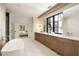 Bright bathroom featuring double vanity, soaking tub and glass enclosed shower at 3292 Lenox Ne Pl, Atlanta, GA 30324