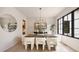 Bright and modern dining room featuring large windows, an elegant chandelier, and stylish decor at 3292 Lenox Ne Pl, Atlanta, GA 30324