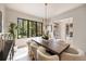 Bright dining room featuring a large table and chairs, chandelier and large windows at 3292 Lenox Ne Pl, Atlanta, GA 30324