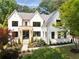 Beautifully landscaped two-story home with a brick exterior, stone entryway and black trim windows at 3292 Lenox Ne Pl, Atlanta, GA 30324