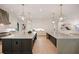 Open kitchen with dual islands, marble countertops, custom lighting, and modern appliances at 3292 Lenox Ne Pl, Atlanta, GA 30324