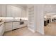 Modern white kitchen with stainless steel appliances and white cabinets with gold hardware and hardwood floors at 3292 Lenox Ne Pl, Atlanta, GA 30324