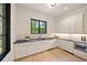 Bright kitchen featuring white cabinetry, black countertops, and stainless steel appliances at 3292 Lenox Ne Pl, Atlanta, GA 30324