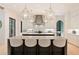 Kitchen with oversized island, pendant lights, seating, and custom range hood at 3292 Lenox Ne Pl, Atlanta, GA 30324