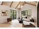 Well-lit living room with high ceilings, black frame windows, and modern decor at 3292 Lenox Ne Pl, Atlanta, GA 30324