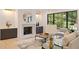 Inviting living room with a fireplace, built-in cabinets, and a large window with views of lush greenery at 3292 Lenox Ne Pl, Atlanta, GA 30324