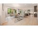 Open floor plan with living room featuring large windows and adjoined kitchen area at 3292 Lenox Ne Pl, Atlanta, GA 30324