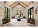 Bright living room with vaulted ceilings, exposed beams, and black frame windows at 3292 Lenox Ne Pl, Atlanta, GA 30324