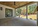 Spacious covered patio with stone flooring, ceiling fan, and view to a lush green backyard at 3292 Lenox Ne Pl, Atlanta, GA 30324