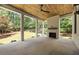 Covered patio with a stone fireplace, ceiling fan, and a view of the landscaped backyard at 3292 Lenox Ne Pl, Atlanta, GA 30324