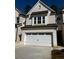 Charming two-story home with a white brick exterior, a two-car garage, and a neatly manicured lawn at 4160 Cavalier Way, Duluth, GA 30097