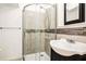 Well-maintained bathroom featuring a glass shower door, tile surround, and sleek fixtures at 4837 Mystere Sw Cir, Lilburn, GA 30047