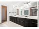 A well-lit bathroom featuring double vanities, sleek fixtures, and bright natural light at 4837 Mystere Sw Cir, Lilburn, GA 30047