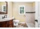 Bathroom featuring vanity, window, toilet, and tiled shower at 4837 Mystere Sw Cir, Lilburn, GA 30047