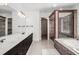 Luxurious bathroom featuring double vanity, a soaking tub, and a separate glass enclosed shower at 4837 Mystere Sw Cir, Lilburn, GA 30047