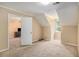 Bedroom with neutral carpeting, view of an adjacent room, and bright window at 4837 Mystere Sw Cir, Lilburn, GA 30047