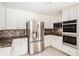 Well-equipped kitchen featuring stainless steel appliances, granite counters, and ample storage at 4837 Mystere Sw Cir, Lilburn, GA 30047