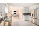 Open kitchen area with granite counters, white cabinets, and seamless flow into the living room at 4837 Mystere Sw Cir, Lilburn, GA 30047
