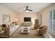 Bright living room showcasing stylish furnishings, neutral tones, plantation shutters, and a ceiling fan at 4837 Mystere Sw Cir, Lilburn, GA 30047