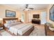 Spacious staged bedroom with ceiling fan, rug, and a large bed perfect for a relaxing retreat at 4837 Mystere Sw Cir, Lilburn, GA 30047