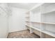 Walk-in closet with carpet and metal shelving at 4837 Mystere Sw Cir, Lilburn, GA 30047