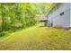 The backyard features a large grass lawn and mature trees at 6662 Birchwood Ct, Winston, GA 30187