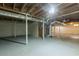 The unfinished basement has concrete floors, exposed ductwork and beams and white painted walls at 6662 Birchwood Ct, Winston, GA 30187