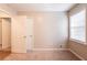 This bedroom features neutral paint, carpet flooring, and natural light from the window at 6662 Birchwood Ct, Winston, GA 30187