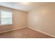 This bedroom features neutral paint, carpet flooring, and natural light from the windows with white blinds at 6662 Birchwood Ct, Winston, GA 30187