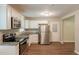 Bright and modern kitchen equipped with stainless steel appliances, granite counters, white cabinetry, and new hardwood floors at 6662 Birchwood Ct, Winston, GA 30187
