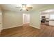 Well-lit living room featuring wood floors that transitions to a kitchen with stainless steel appliances at 6662 Birchwood Ct, Winston, GA 30187