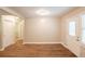 Bright living room with wood floors, neutral paint, and lots of natural light from front door with window at 6662 Birchwood Ct, Winston, GA 30187