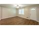 Bright living room featuring wood floors, ceiling fan, and natural light from window and front door at 6662 Birchwood Ct, Winston, GA 30187