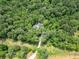 An aerial view displays a home hidden amongst a dense forest ensuring unmatched privacy from the outside world at 13935 Brown Bridge Rd, Covington, GA 30016