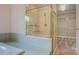 Bathroom showcasing a glass-enclosed shower and access to a closet area at 13935 Brown Bridge Rd, Covington, GA 30016