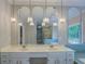 Bathroom vanity featuring double sinks, multiple mirrors, and modern lighting at 13935 Brown Bridge Rd, Covington, GA 30016
