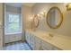Bathroom with oval mirrors, a window and patterned tile flooring at 13935 Brown Bridge Rd, Covington, GA 30016