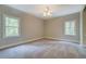 A spacious bedroom with two windows and neutral carpeting at 13935 Brown Bridge Rd, Covington, GA 30016