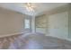 Bedroom features a ceiling fan, built-in shelving, and closet space at 13935 Brown Bridge Rd, Covington, GA 30016