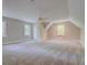 An upstairs bonus room is well-lit, spacious, and carpeted at 13935 Brown Bridge Rd, Covington, GA 30016