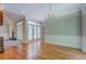 Spacious dining room boasts hardwood floors, classic chandelier, and seamless flow to living area at 13935 Brown Bridge Rd, Covington, GA 30016