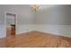 Elegant dining room with hardwood floors, wainscoting detail, and a classic chandelier at 13935 Brown Bridge Rd, Covington, GA 30016