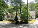 Charming home exterior featuring stone accents and a well-manicured, heavily wooded yard for optimal privacy at 13935 Brown Bridge Rd, Covington, GA 30016