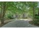 Charming home featuring a welcoming front exterior with a long driveway surrounded by mature trees at 13935 Brown Bridge Rd, Covington, GA 30016