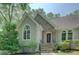 Inviting front entrance with stone accents, arched windows, and well-maintained landscaping at 13935 Brown Bridge Rd, Covington, GA 30016